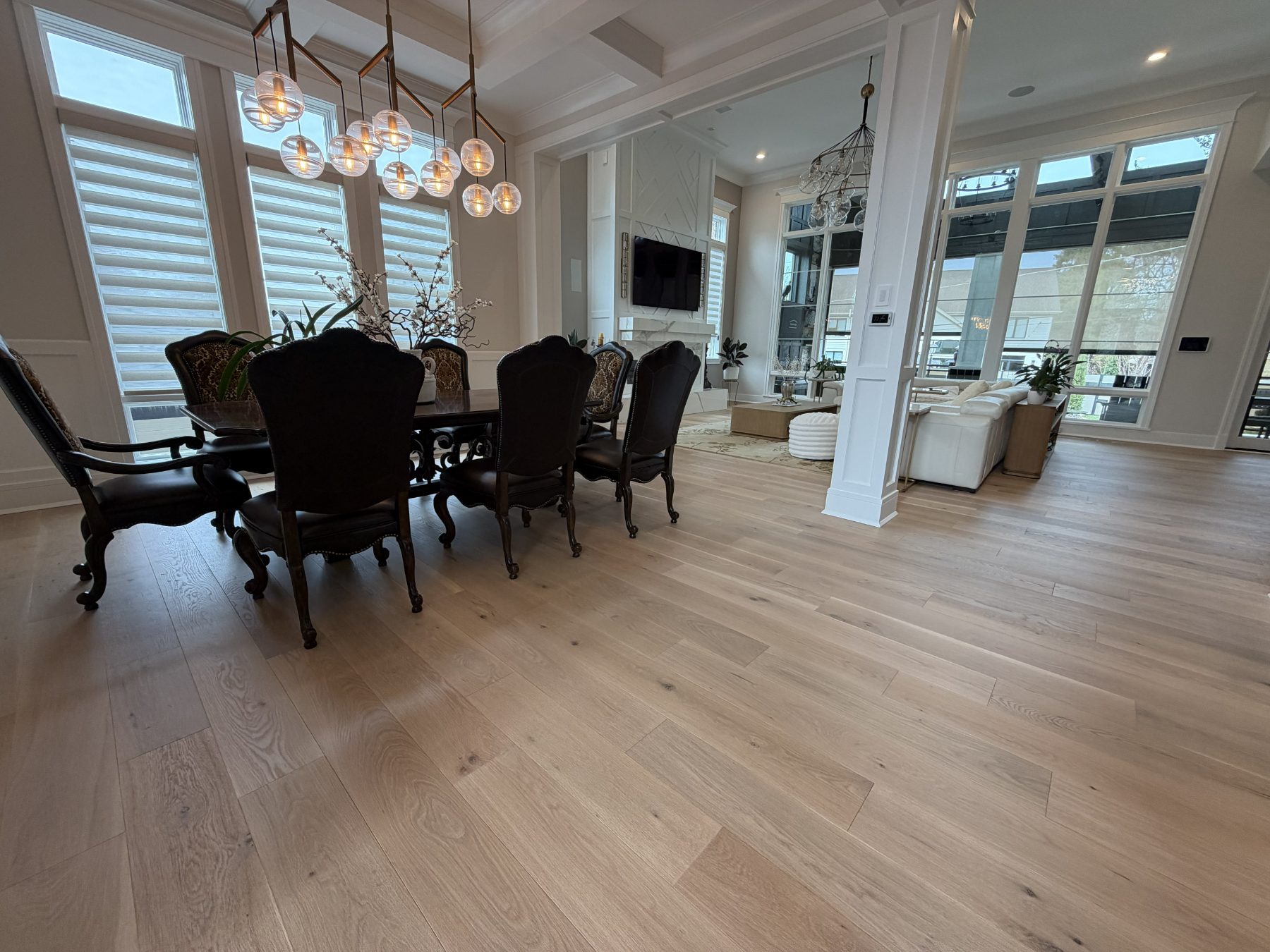 Wide-plank white oak through a dining and great room