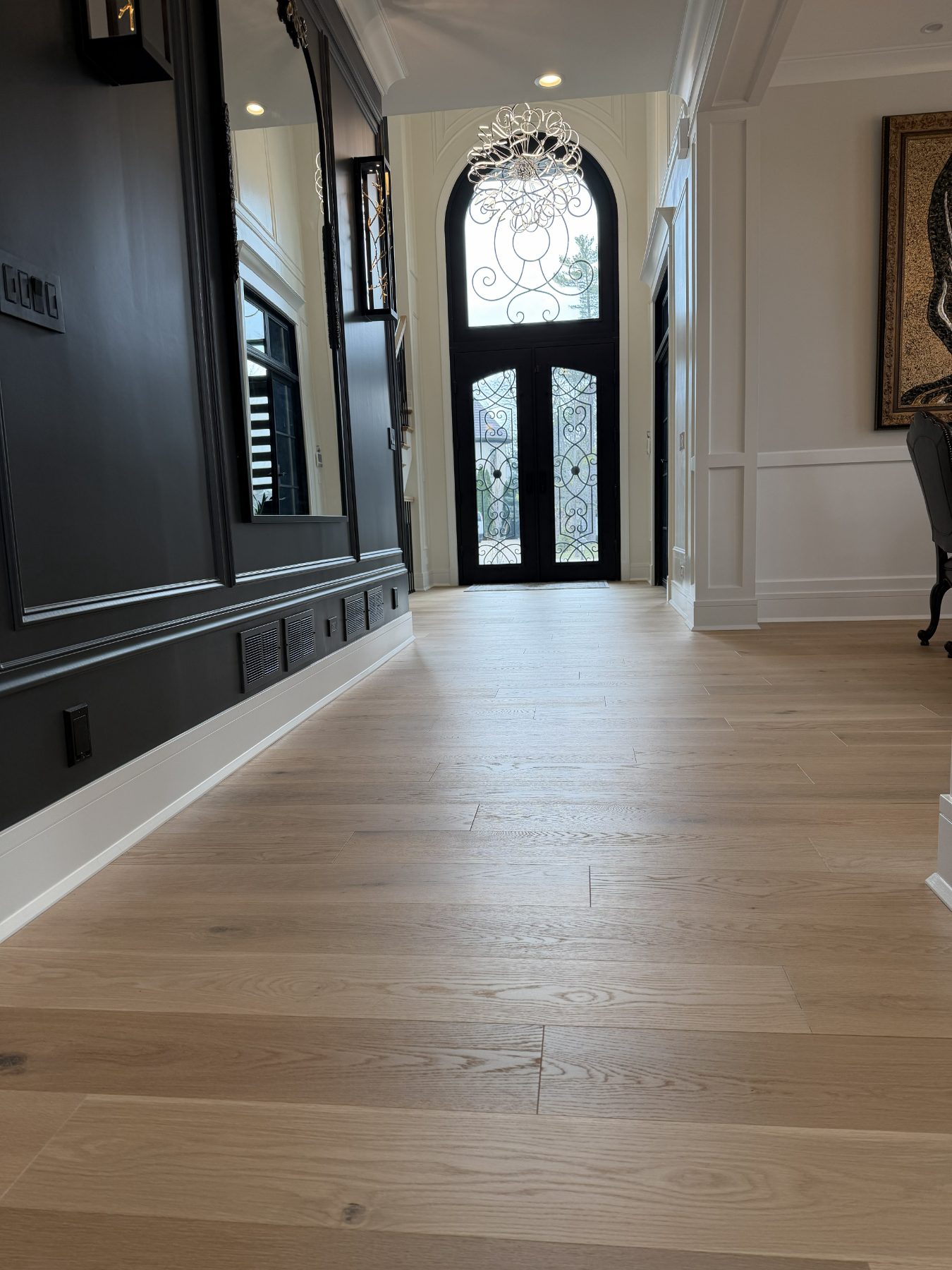 White oak plank flooring in a two-story entry foyer