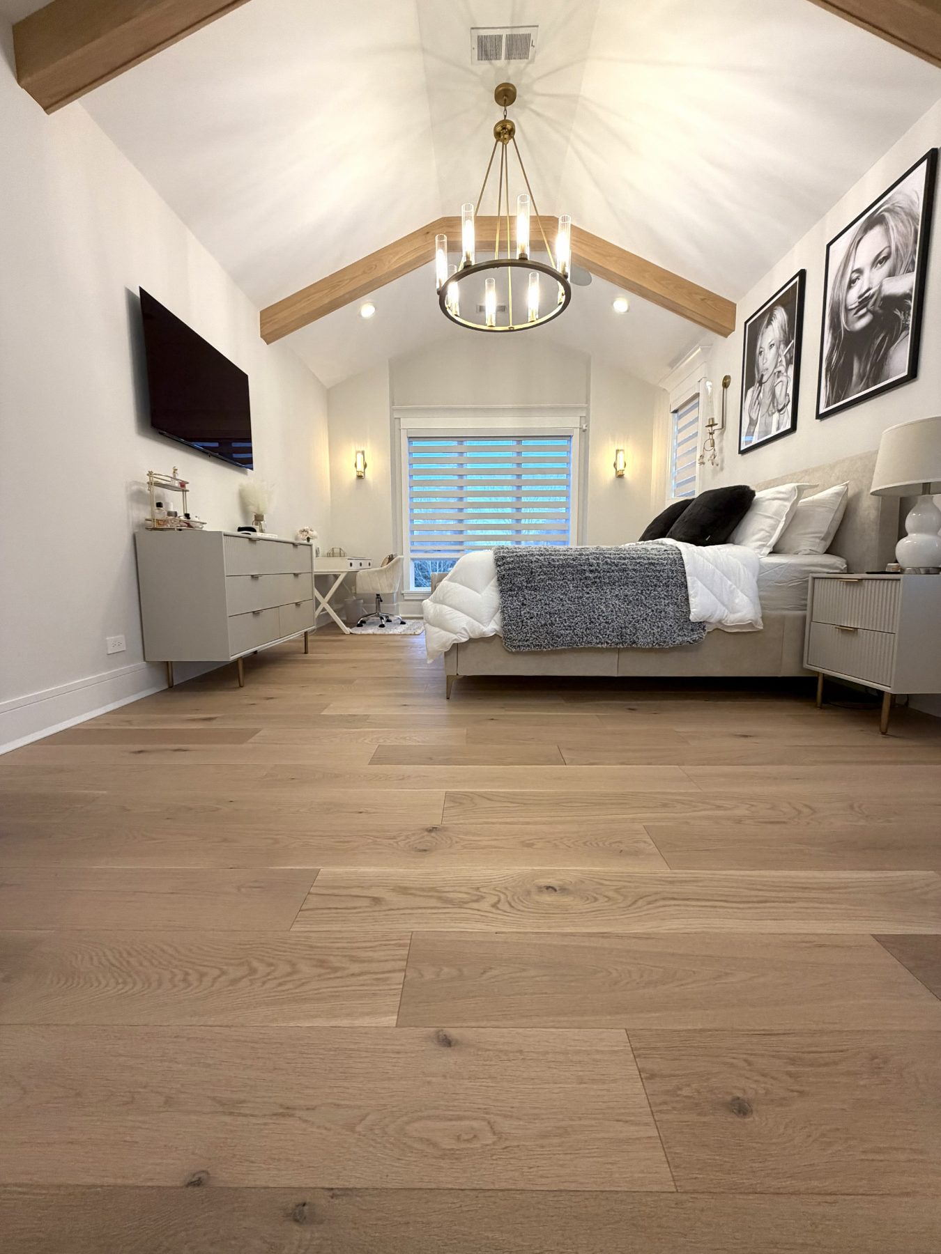 Wide-plank white oak in a vaulted primary bedroom